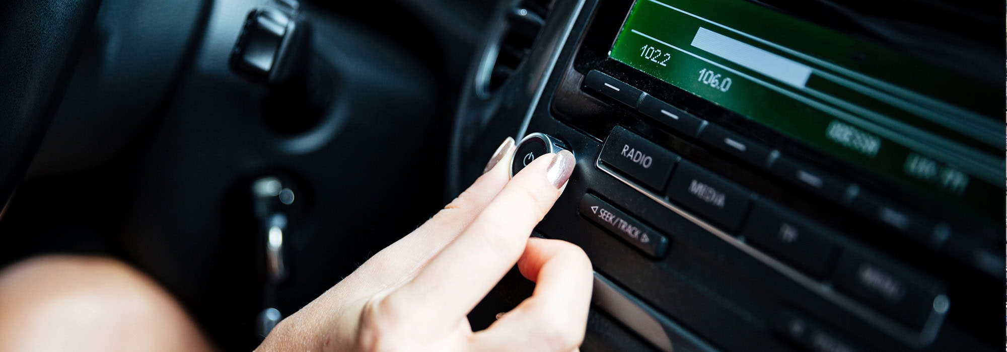 woman selecting radio station